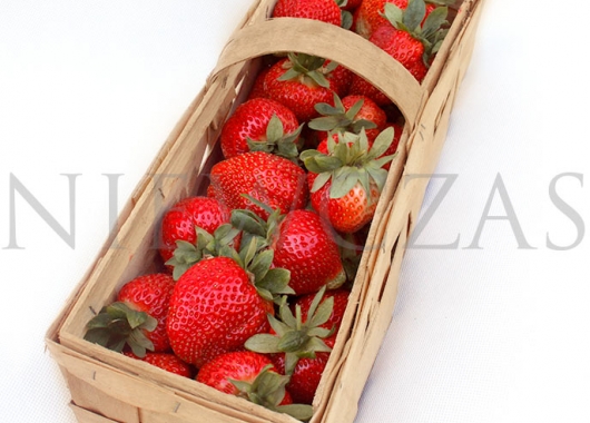Grandarosa strawberry fruits in a wooden box